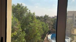 a view of a swimming pool from a window at فيلا كامله للايجار in Kafr Ghaţāţī +12 photos
