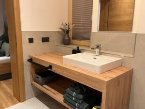 a bathroom with a sink and a counter with towels at Apartment Winkl 65 in Maria Alm am Steinernen Meer
