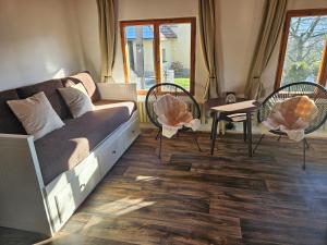 a living room with a couch and chairs and a table at Rodinná chata Alexa, Beskydy in Prostřední Bečva