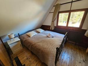 a bedroom with a bed with a teddy bear on it at Rodinná chata Alexa, Beskydy in Prostřední Bečva