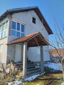 a house with a porch and stairs in front of it at Summer Garden View in Belgrade