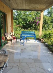 a blue bench and chairs on a patio at Summer Garden View in Belgrade