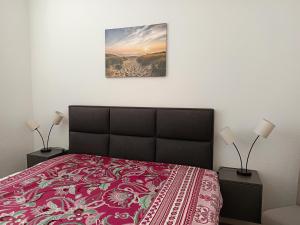 a bedroom with a bed with a red bedspread at Familie Lehmann in Gera