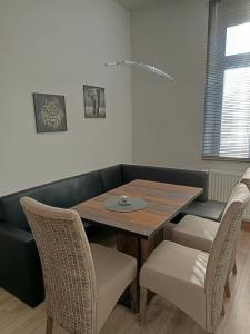 a dining room with a table and chairs at Familie Lehmann in Gera +7 photos