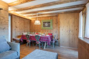 a dining room with a table and chairs at Chalet Capriol by My Villa Collection in Cortina dʼAmpezzo