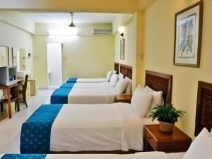 En eller flere senge i et værelse på Seapark Condotel Hotel