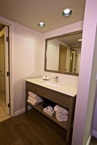 a bathroom with a sink and a mirror at 456 Embarcadero Inn & Suites in Morro Bay