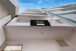 a sign on the side of a white building at Collection O Sector 18 Noida Formerly True Residency in Okhla