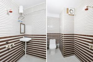 a bathroom with a white toilet and a sink at Collection O Sector 18 Noida Formerly True Residency in Okhla