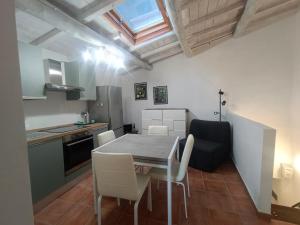 a kitchen and dining room with a table and chairs at IN THE HILLS NEAR THE LAKE, Relax e Comfort in Grotte di Castro