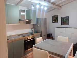 a kitchen with a table and a counter top at IN THE HILLS NEAR THE LAKE, Relax e Comfort in Grotte di Castro +2 photos