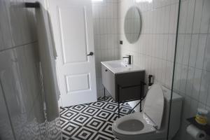 a bathroom with a toilet and a sink and a mirror at Travellers Palm in Koh Phangan
