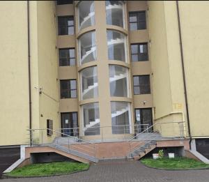 a building with a staircase in front of it at Promenada Mall Apartment4you in Craiova