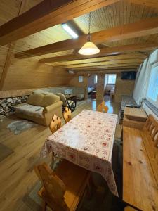 a living room with a table and a couch at Halka Apartment 4 in Rabčice