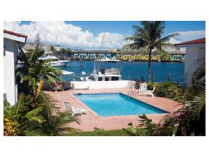 a swimming pool with a boat in a marina at Beauport One-Bedroom Apartment in Freeport