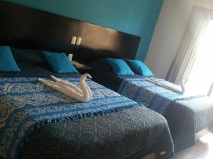 Postel nebo postele na pokoji v ubytování Hotel Real Colonial