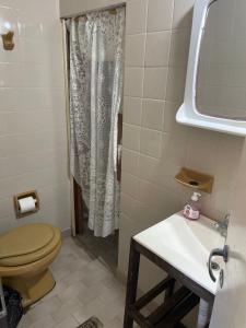 a bathroom with a toilet and a sink at Teresita6 in Santa Teresita