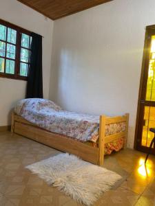 a bedroom with a bed with a rug and a window at Teresita6 in Santa Teresita