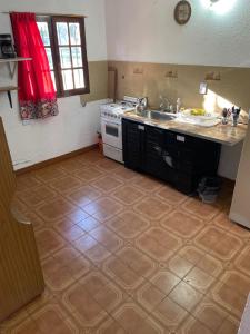 a kitchen with a sink and a stove at Teresita6 in Santa Teresita