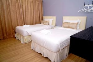 Postel nebo postele na pokoji v ubytování Alami Garden Hotel