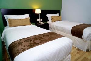 Postel nebo postele na pokoji v ubytování Alami Garden Hotel