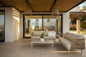 a living room with a couch and a coffee table at Plaka Oasis - Private Pool - Walk to Beach & Shops in Plaka