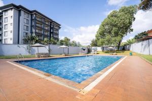 a swimming pool in front of a building at Royal Homes in Nairobi