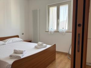 Giường trong phòng chung tại RESIDENZE PLANET - mansarda Terzo piano - Premium Villas