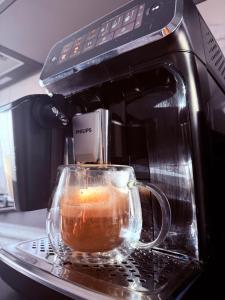 a glass cup sitting on top of a microwave at Apartamentul lui Radu in Caracal