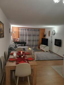 a living room with a table and a couch at San's resort in Vionnaz