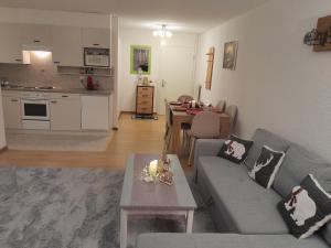 a living room with a couch and a table at San's resort in Vionnaz