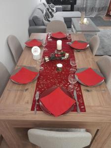 a wooden table with red napkins and a red table runner at San's resort in Vionnaz +11 photos