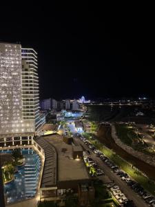 a view of a city at night with a building at Long Beach, İskele, Grand Sapphire Resort - Pool View Luxury Studio in Paralimni