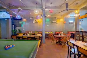 a pool table in a restaurant with tables and chairs at Siem Reap Pub Hostel in Siem Reap