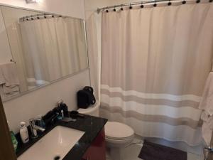 a bathroom with a toilet and a shower curtain at Breath-Taking-View-5 Guest DTskyline 18th Floor in Calgary +19 photos