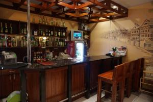 a bar with a counter and a chair in a room at Hotel Ludza in Ludza