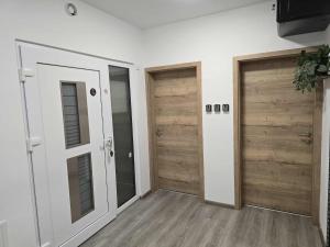 two wooden doors in a room with wooden floors at Prenočišca Dany 3 in Dravograd