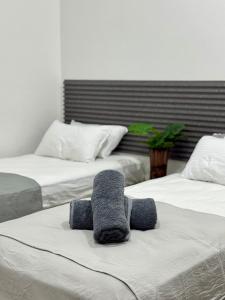 a room with two beds with towels on them at Reinforce Residence in Thulusdhoo