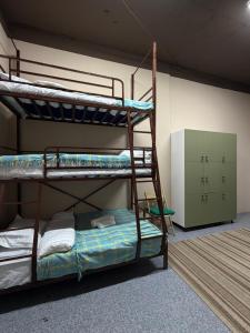 a room with two bunk beds in a room at Sky Tau Hostel in Almaty +18 photos