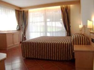 Łóżko lub łóżka w pokoju w obiekcie Residence Club La Betulla