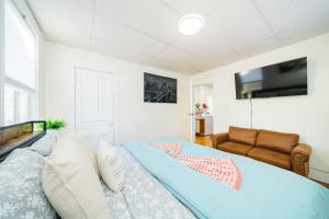a bedroom with a bed and a couch at Cozy 3BR Worcester 1st-floor Apt, Pet-Friendly, Near Clark University, Free Parking 4-1 in Worcester
