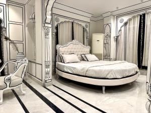 a bedroom with a large bed and a chair at Lalluji Luxe in Jaipur