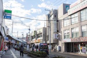 a city street with a bus on the street at Kotori Ayase in Tokyo