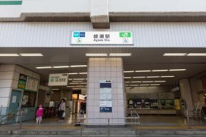 a building with people walking through a shopping mall at Kotori Ayase in Tokyo