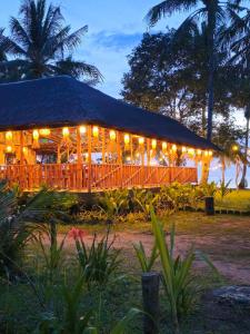 a restaurant lit up at night with lights at BAIBAI Long Beach in New Agutaya