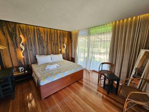 a bedroom with a bed and a table and a window at BAIBAI Long Beach in New Agutaya