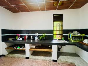 a kitchen with a black and white counter and a sink at Sea Paradise Hidden Villa in Tangalle +37 photos