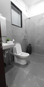 a bathroom with a toilet and a sink and a mirror at Saran Homestay in Agra +15 photos