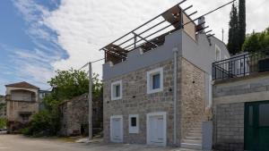 a house with a windmill on top of it at House Vidovic by Villas Guide in Mlinište