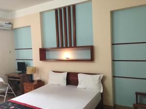 Postel nebo postele na pokoji v ubytování Sunrise Hotel